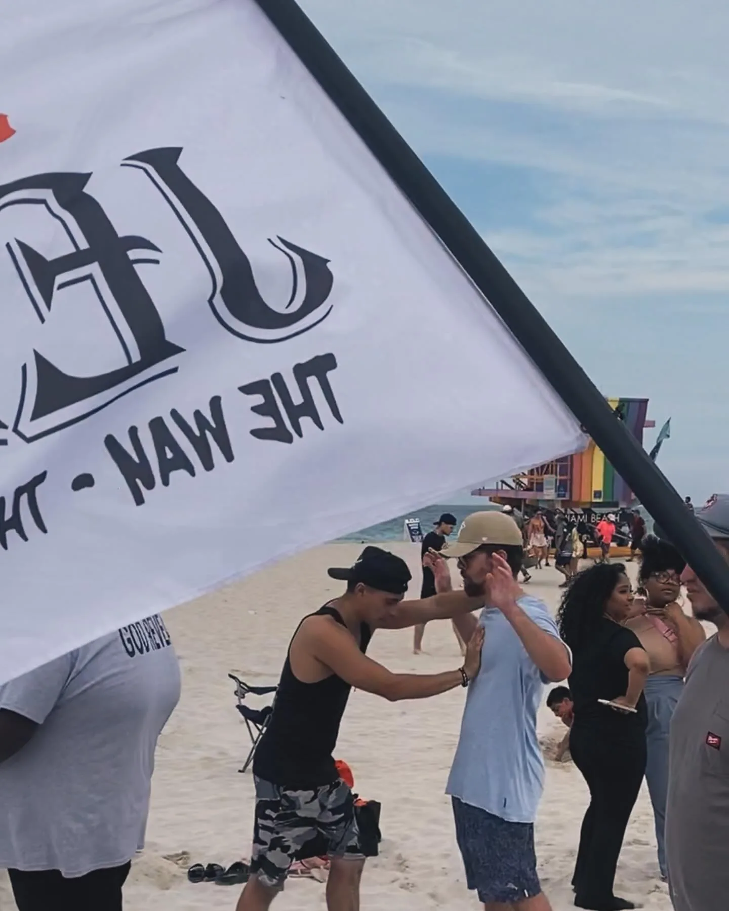 Beach outreach with 99After1 flag